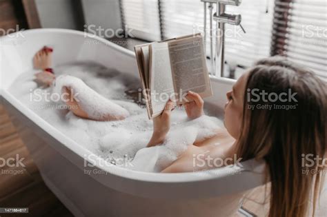 Relaxation And Spa Day Carefree Woman Lying In Foamy Bath Reading Book