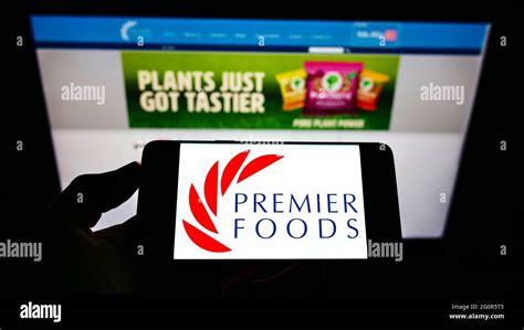 Person holding smartphone with logo of British food manufacturer ...