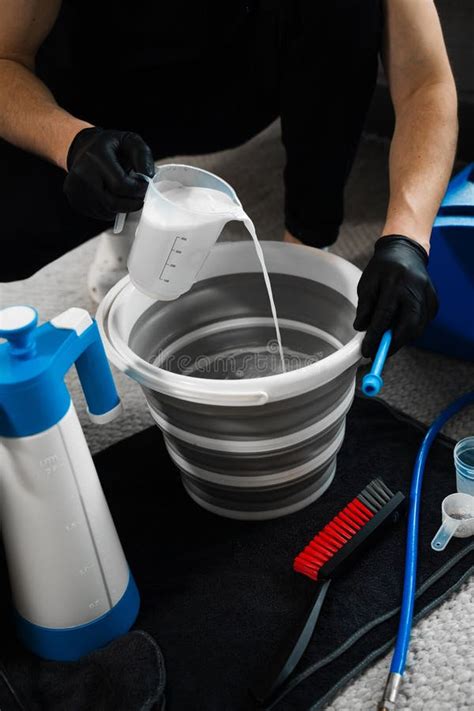 Pouring Oxygen Bleach Mixture In The Bucket For Cleaning Living Room