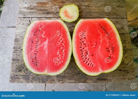 Watermelon Cut In Half On A Wooden Table Stock Image Image Of Juicy Table 277900351