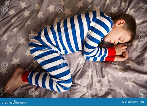 Cute Little Boy Sleeps In Pajames On Bed Fokus Above Stock Photo