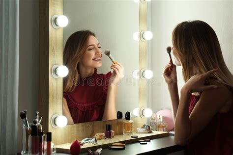 Woman Applying Makeup Near Mirror With Light Bulbs Stock Image Image