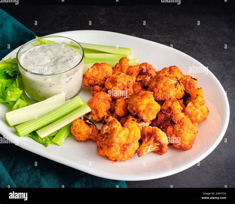 Buffalo Cauliflower Bites Served With Celery Sticks And Ranch Dressing Vegetarian Snack Foods