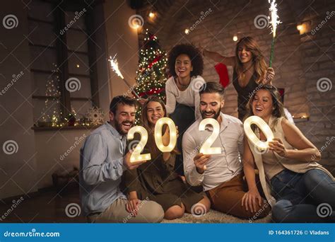 Friends at a New Years Eve Party Stock Photo - Image of holding, christmas: 164361726