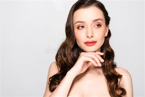 Naked Beautiful Brunette Woman With Curls And Makeup Touching Chin On Grey Stock Image Image