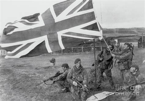 Soldier Hoisting Union Flag by Bettmann