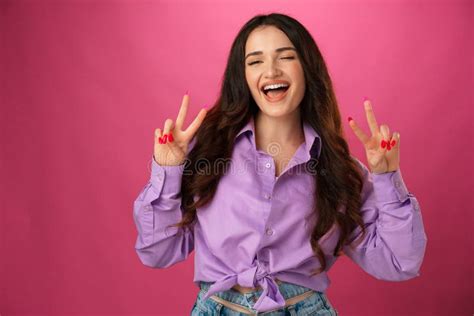 Happy Smiling Woman Showing Victory Sign Against Pink Background Stock