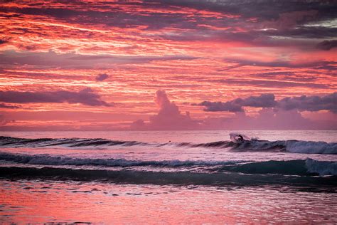 Vibrant Pink Sunset Over The Gentle Waves On A Beach In Hawaii ...