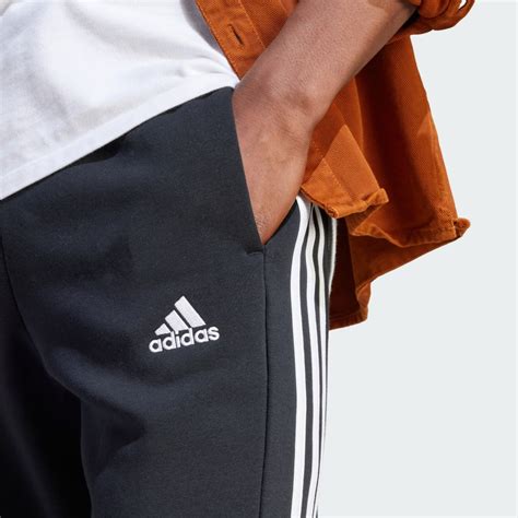 Adidas Essentials Fleece 3 Stripes Tapered Cuff Pants Black Adidas Uae