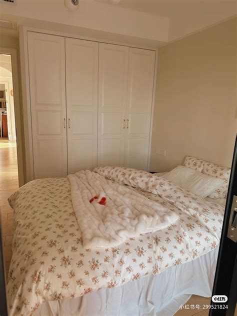 An Empty Bed In A Bedroom With White Cupboards