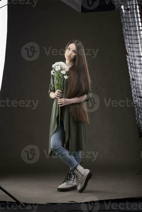 Beautiful Brunette Girl With Very Long Hair Under Studio Equipment In A Photo Studio Woman