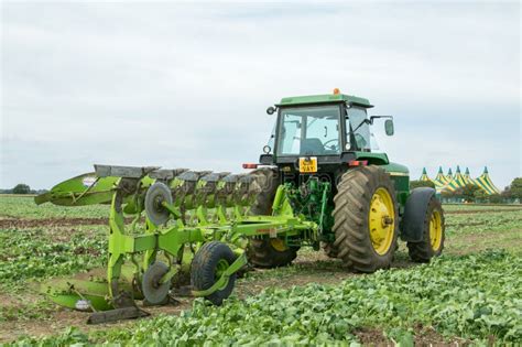 Modern John Deere Tractor Pulling A Plough Editorial Photography