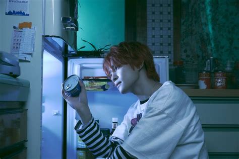 A Woman With Red Hair Is Looking In The Refrigerator