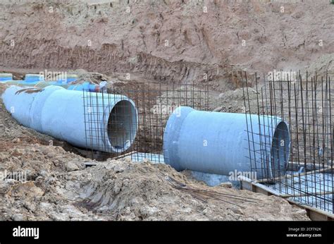 Laying of underground storm sewer pipes at construction site ...