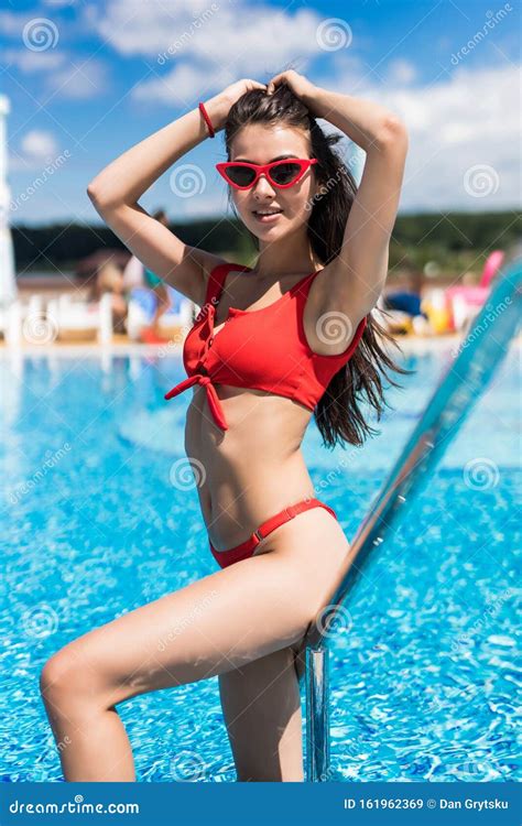 Portrait Of A Beautiful Woman Getting Out Of A Swimming Pool Outdoor