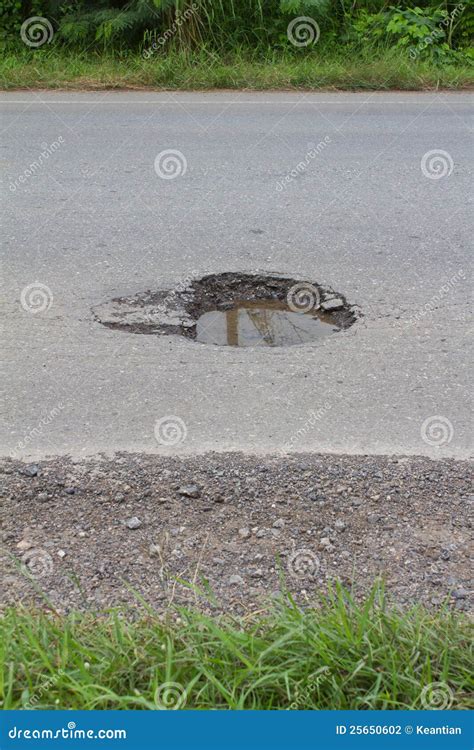 Dangerous Potholes In The Asphalt Rural Road. Road Damage Royalty-Free ...