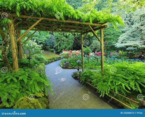 Pergola Over the Garden Walkway Stock Photo - Image of lush, outdoor ...