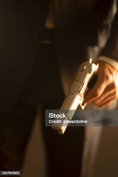 Male Detective Spy Killer Holding Pistol Gun In Dramatic Novel Book