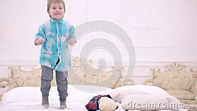 Funny Kids Jumping on Bed. Happy Child Boy Having Fun Jumps and Plays ...