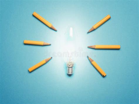 glowing light bulb   pencils  light rays  ideas