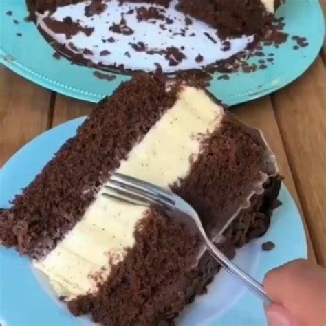 Someone Is Cutting Into A Piece Of Cake On A Blue Plate With A Knife