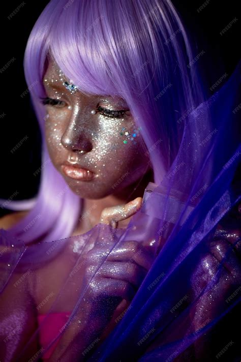 A girl with purple hair and glowing skin an alien or a fairy with