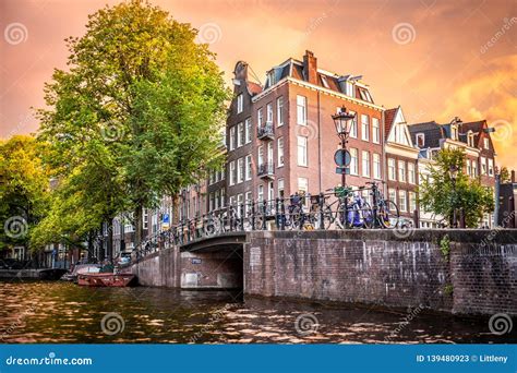 Amsterdam at Sunset with Canal, Bridge and Buildings Stock Image ...