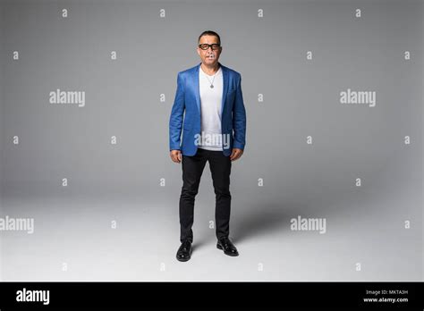 Full Length Portrait Of Confident Mature Businessman In Formals Standing Isolated Over White