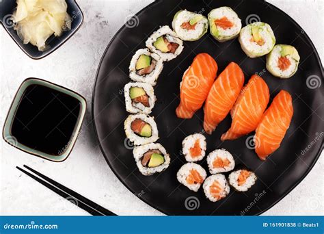 Close Up Of Sashimi Sushi Set With Chopsticks And Soy Sushi Roll With