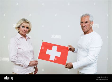 Mature Man And Mature Woman Holding Swiss Flag Stock Photo Alamy