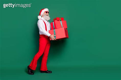 Full Length Photo Of Positive Dreamy Guy Wear X Mas Costume Delivering Presents Pile Empty Space