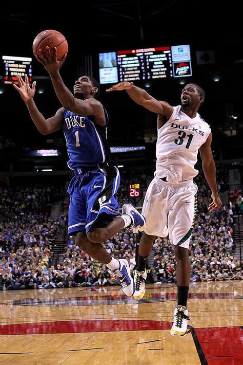 Kyrie Irving of the Duke Blue Devils goes for a layup against Tyrone... | Kyrie irving, Kyrie ...