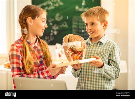 Pleased Blonde Girl Looking At Her Classmate Stock Photo Alamy