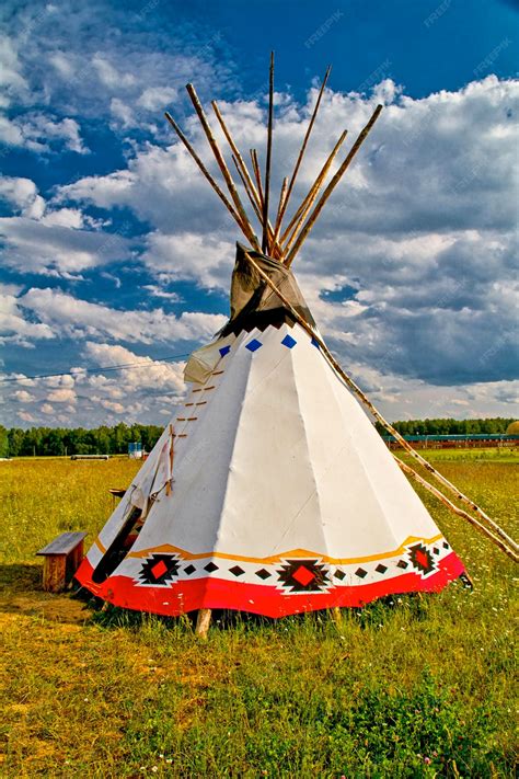 Premium Photo An Indian Teepee Set Up In A Meadow Among Pine Woods Portrait Orientation