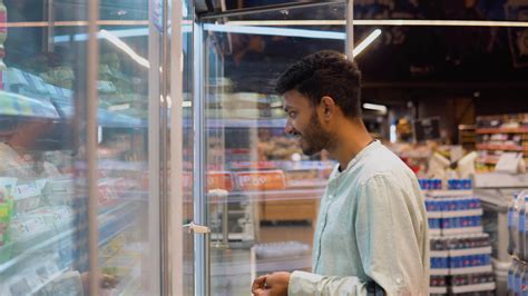 Indian asian man doing shopping at market while buying quail eggs