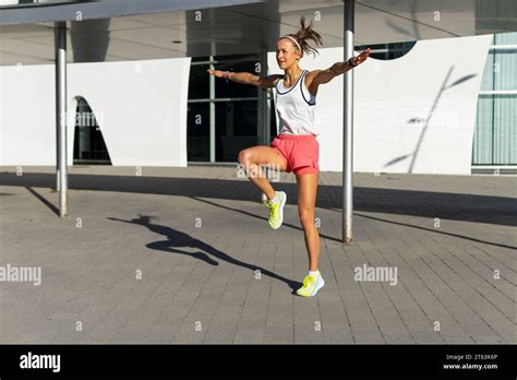 Photo Of Metropolitan Fitness Active Woman Stretching In White Tank