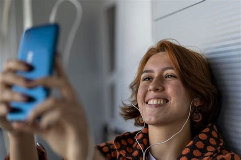 Jovem latino americana de 22 anos ouve música seus fones de ouvido