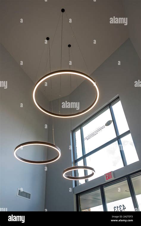 Large Circular Lights Hanging From The Ceiling Inside A Doctor S Office