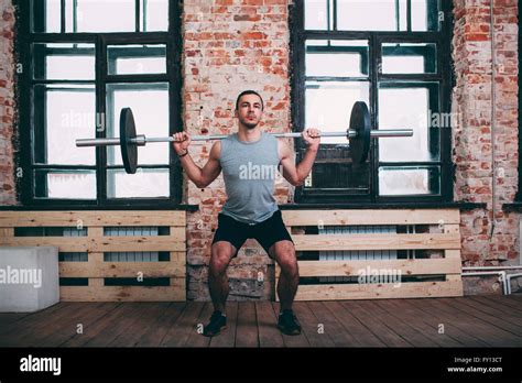 Determined Man Lifting Barbell At Gym Stock Photo Alamy