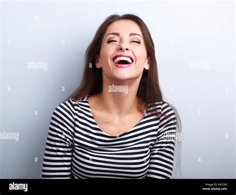 Happy natural laughing young casual woman with wide open mouth and ...