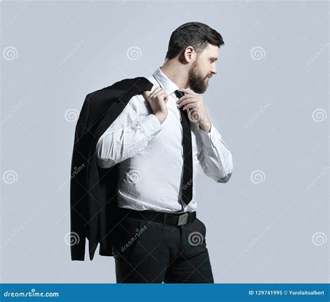 Businessman Holding His Jacket Over His Shoulder And Straightens His