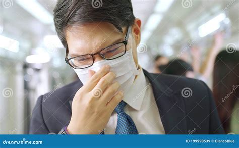 Young Man Wearing Face Mask Travels On Crowded Subway Train Stock Image