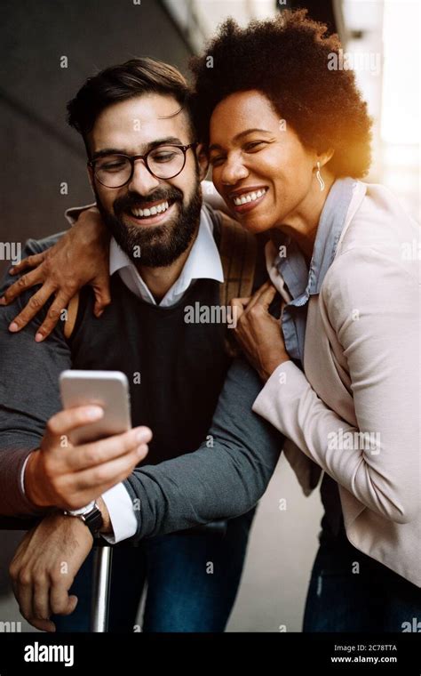 Happy Businesspeople Using Technology Devices Gadgets Near Wall Of