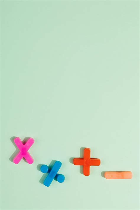 Math Symbols in Various Colors on Blue Surface · Free Stock Photo