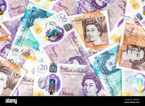 New British pound polymer notes scattered Stock Photo - Alamy