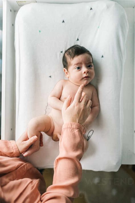 From Above Faceless Woman Touching Tenderly Naked Newborn Infant Lying