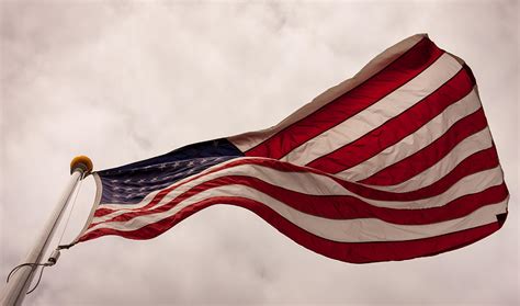 American Flag Blowing In The Wind Photograph By Laura Duhaime