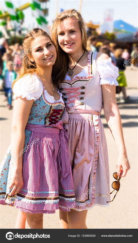 Attractive young women at German funfair Oktoberfest with traditional ...