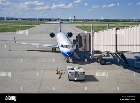 Airplane In Airport With Boarding Ramp Stock Photo - Alamy