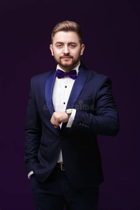 Handsome Man In Tuxedo And Bow Tie Looking At Camera Fashionable